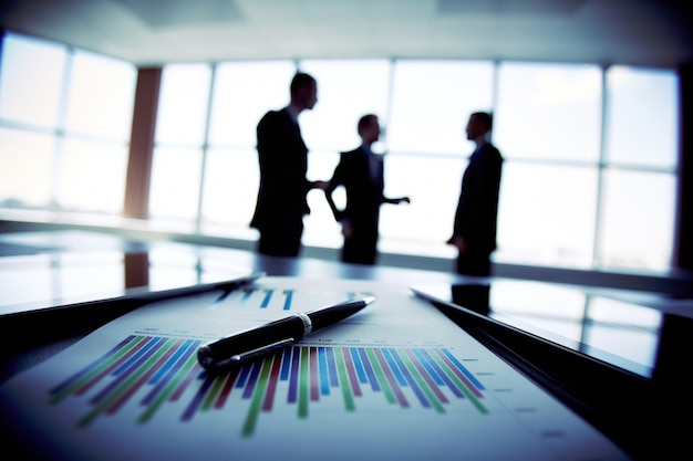 Pen on a sheet of paper with a graph illustrating strategic analysis and planning for eCommerce acquisitions.