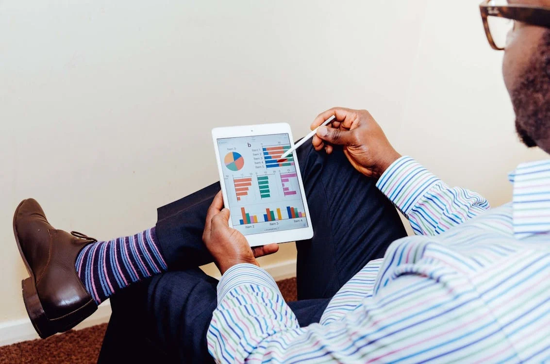 A person looking at statistics on a tablet