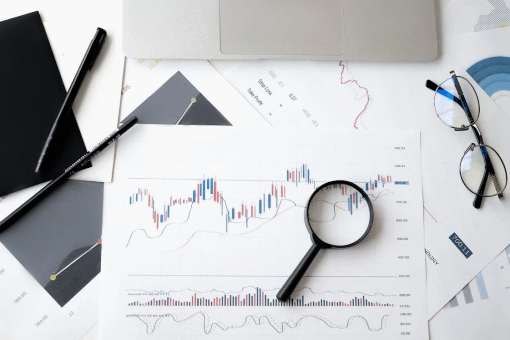 A magnifying glass placed on a paper with graphs