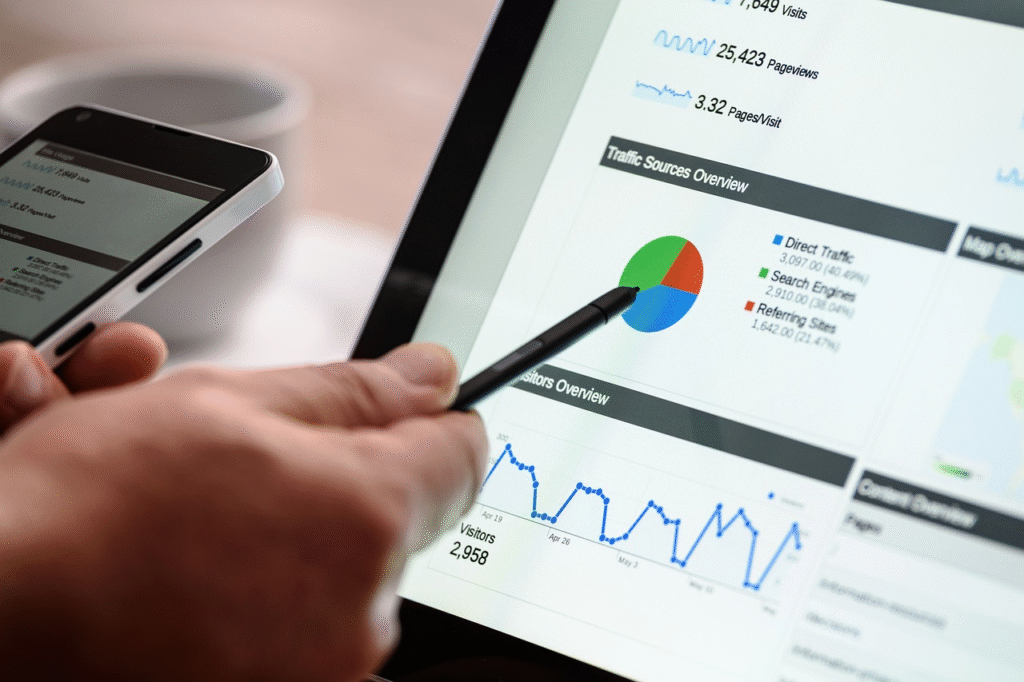 A hand pointing to the graph on a tablet with a pen
