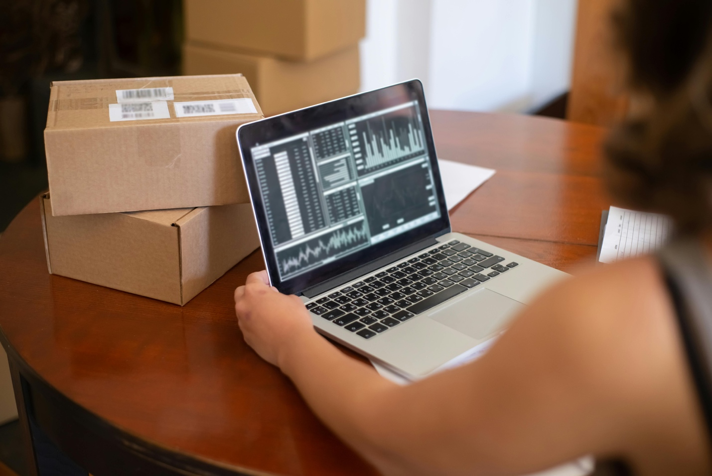 A person is viewing charts and graphs on a laptop