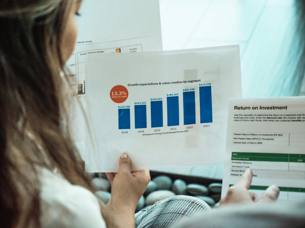 A person reviewing financial data and ROI metrics on a laptop 