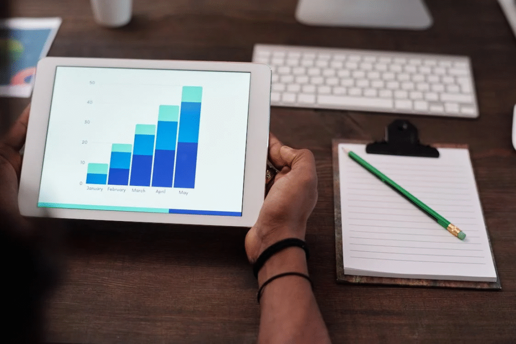 A person holding a tablet with graphs